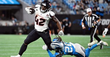 Houston Texans running back Owen Wright (42) runs with the ball against Carolina Panthers cornerback Tyrek Funderburk (20) during the second half at Bank of America Stadium, Charlotte, North Carolina, U.S., Aug 28, 2026. (Reuters Photo via Bob Donnan-Imagn Images)