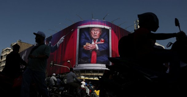 People walk near a billboard depicting U.S. President Donald Trump on a building in Tehran, Iran, Sept. 2, 2026. (Reuters Photo)