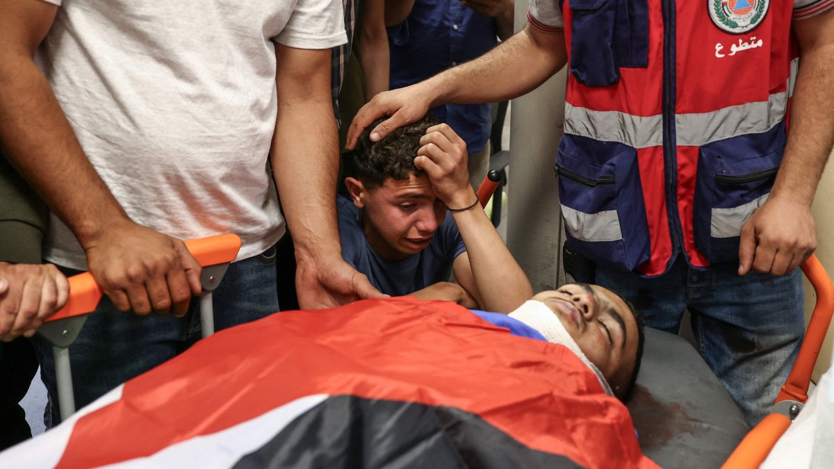 Relatives of Khalil Rasem Khalil Shahada mourn over his body during the funeral of two Palestinians killed by Israeli army in al-Mughayyir, east of Ramallah, occupied West Bank, Sept. 2, 2026. (AFP Photo)