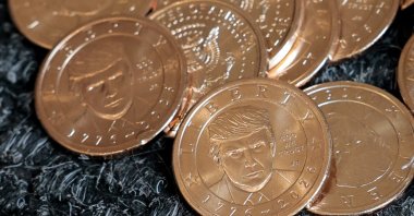 U.S. President Donald Trump's portrait on $1 coins, in honor of the nation's 250th anniversary of independence, on the day the coin is released for sale is seen in this illustration taken on Sept. 2, 2026. (Reuters Photo)