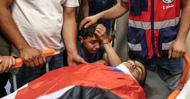 Relatives of Khalil Rasem Khalil Shahada mourn over his body during the funeral of two Palestinians killed by Israeli army in al-Mughayyir, east of Ramallah, occupied West Bank, Sept. 2, 2026. (AFP Photo)