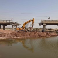 An excavator works on the Gachin Bridge, which was damaged by a U.S. strike, along the road between Bandar Abbas and Bandar Khamir, southern Iran, Aug. 11, 2026. (AFP Photo)