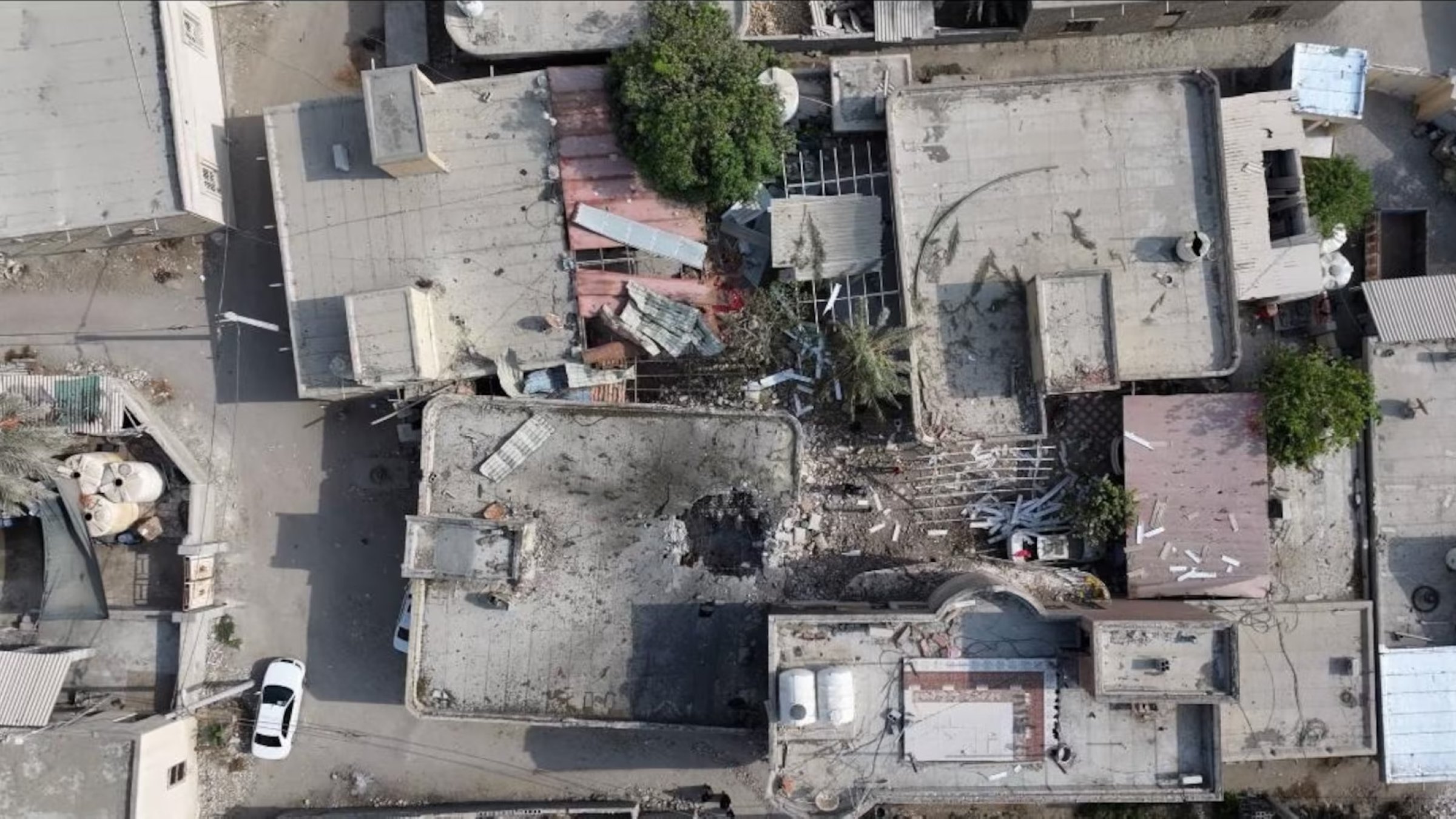 A screengrab from a drone video taken on Sept. 2 shows damage to a courtyard and a hole in the roof of a home where a wedding ceremony was held. (Reuters Photo)