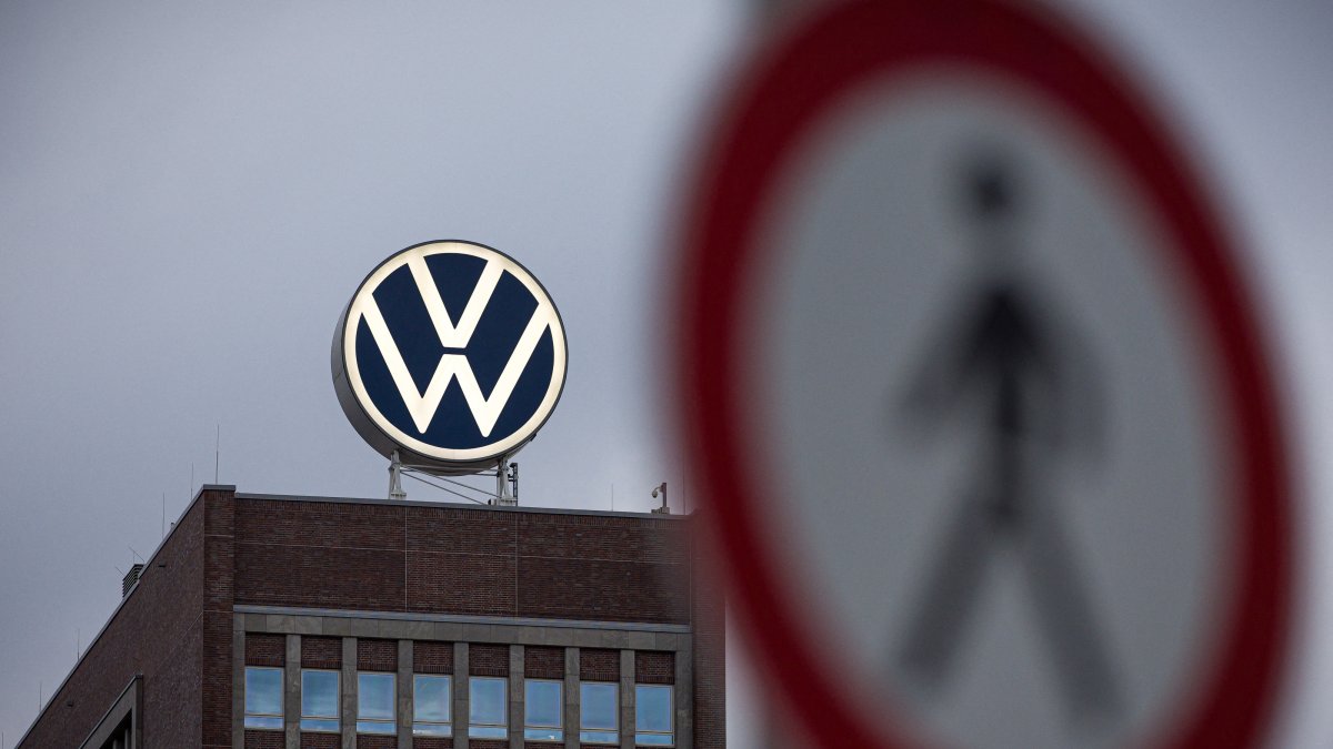 A view of a pedestrian traffic sign near the Volkswagen brand skyscraper in Wolfsburg, Germany, Sept. 4, 2026. (AP Photo)