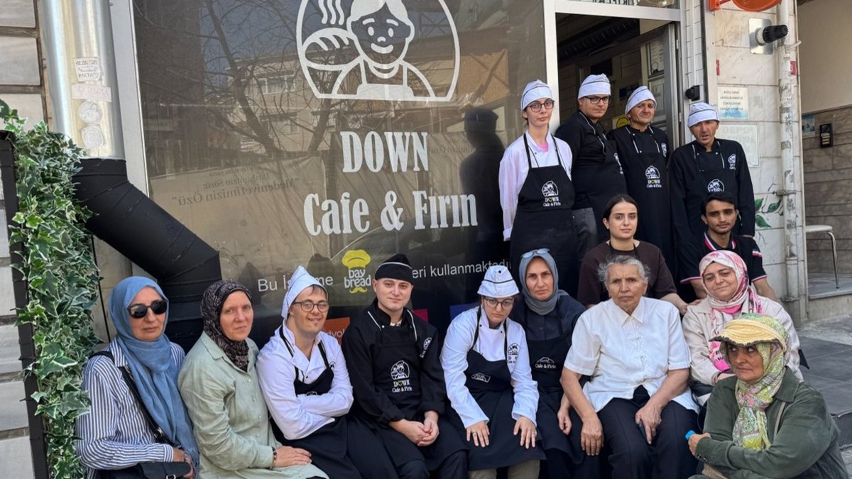 Young people and volunteer mothers pose in front of Down Kafe-Fırın, Istanbul, Türkiye, Sept. 4, 2026. (AA Photo)