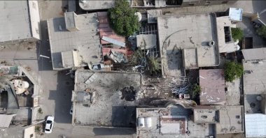 A screengrab from a drone video taken on Sept. 2 shows damage to a courtyard and a hole in the roof of a home where a wedding ceremony was held. (Reuters Photo)