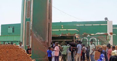 People gather to clear debris from the complex of a mosque that was hit by a drone strike in the El-Droshab area of Khartoum North, Sudan, Aug. 12, 2026. (AFP Photo)