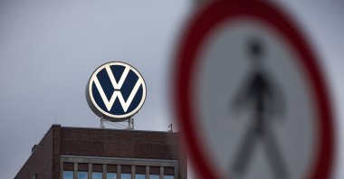 A view of a pedestrian traffic sign near the Volkswagen brand skyscraper in Wolfsburg, Germany, Sept. 4, 2026. (AP Photo)