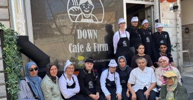 Young people and volunteer mothers pose in front of Down Kafe-Fırın, Istanbul, Türkiye, Sept. 4, 2026. (AA Photo)
