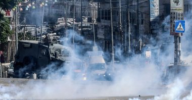 Israeli forces block a street and fire tear gas during an Israeli raid on the UNRWA Vocational Training Centre, located between the Kafr Aqab neighbourhood and the Qalandia refugee camp, south of the West Bank city of Ramallah, Aug. 25, 2026. (AFP Photo)