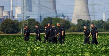 German police officers search a field near a power plant after a second sabotage attempt on Germany's electricity grid, with local police saying they are investigating an attack on a substation in Bergheim, Germany, Sept. 2, 2026. (Reuters Photo)