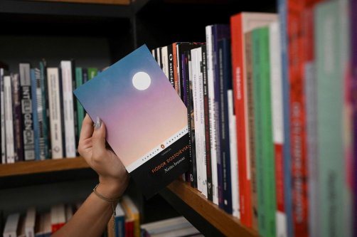 A bookseller gets a copy of the book "White Nights" of Russian writer Fyodor Dostoevsky from the shelf of the Leonardo Da Vinci bookstore, downtown Rio de Janeiro, Brazil, Aug. 28, 2026. (AFP Photo)