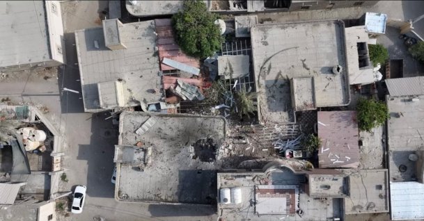 A screengrab from a drone video taken on Sept. 2 shows damage to a courtyard and a hole in the roof of a home where a wedding ceremony was held. (Reuters Photo)