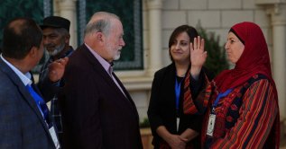 U.S. Ambassador to Israel Mike Huckabee meets a resident of Turmus Ayya, a Palestinian town near Ramallah, West Bank, Palestine, Sept. 5, 2026. (Reuters Photo)