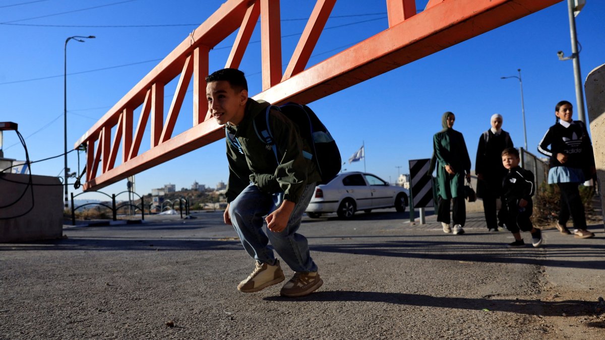 Palestinian students cross an Israeli checkpoint as they return to school for the new academic year, near Hebron, in the Israeli-occupied West Bank, Sept. 6, 2026. (Reuters Photo)