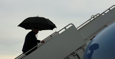 U.S. President Donald Trump holds an umbrella as he boards Air Force One, en route to Bedminster, New Jersey, at Joint Base Andrews, Maryland, U.S., Sept. 4, 2026. (Reuters Photo)
