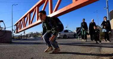 Palestinian students cross an Israeli checkpoint as they return to school for the new academic year, near Hebron, in the Israeli-occupied West Bank, Sept. 6, 2026. (Reuters Photo)
