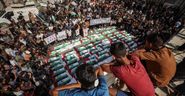 Mourners gather for a mass burial of around 100 Palestinians, including 62 children, whose remains where recovered from rubble, in Gaza City, Palestine, Sept. 6, 2026. (AFP Photo)