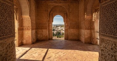 A view from inside the Generalife Palace, looking through a window toward the gardens, Granada, Spain. (Shutterstock Photo)