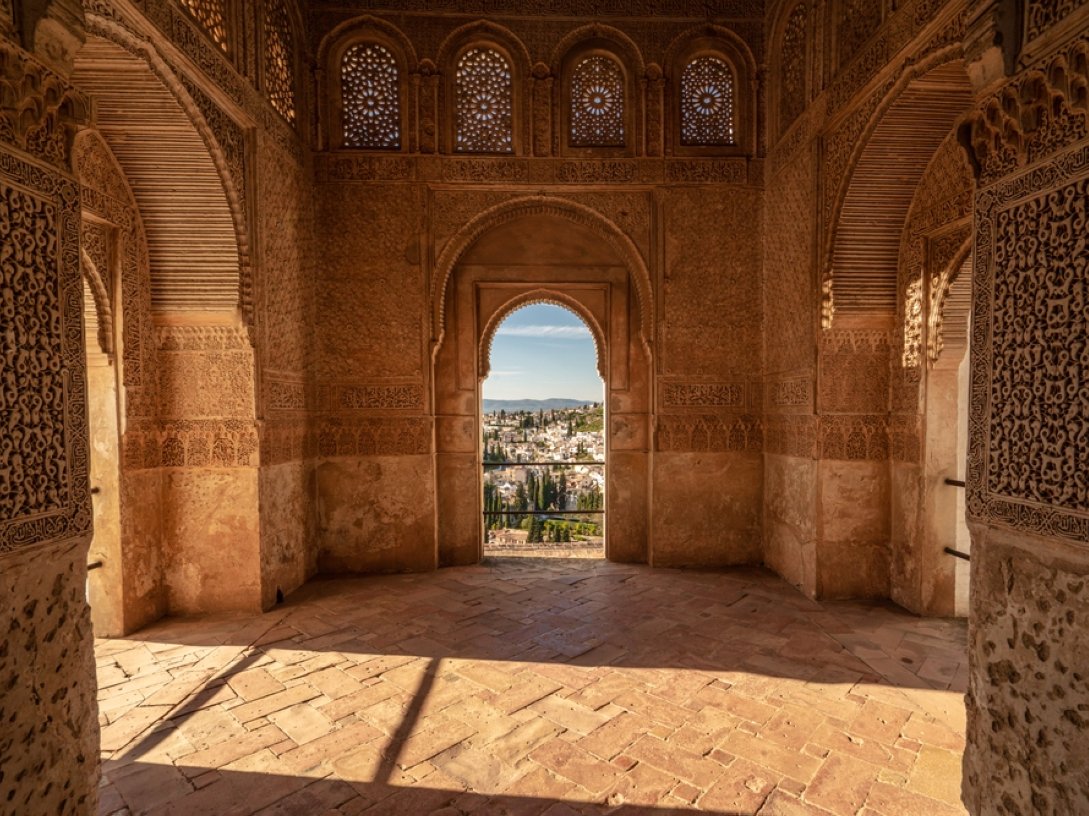 A view from inside the Generalife Palace, looking through a window toward the gardens, Granada, Spain. (Shutterstock Photo)