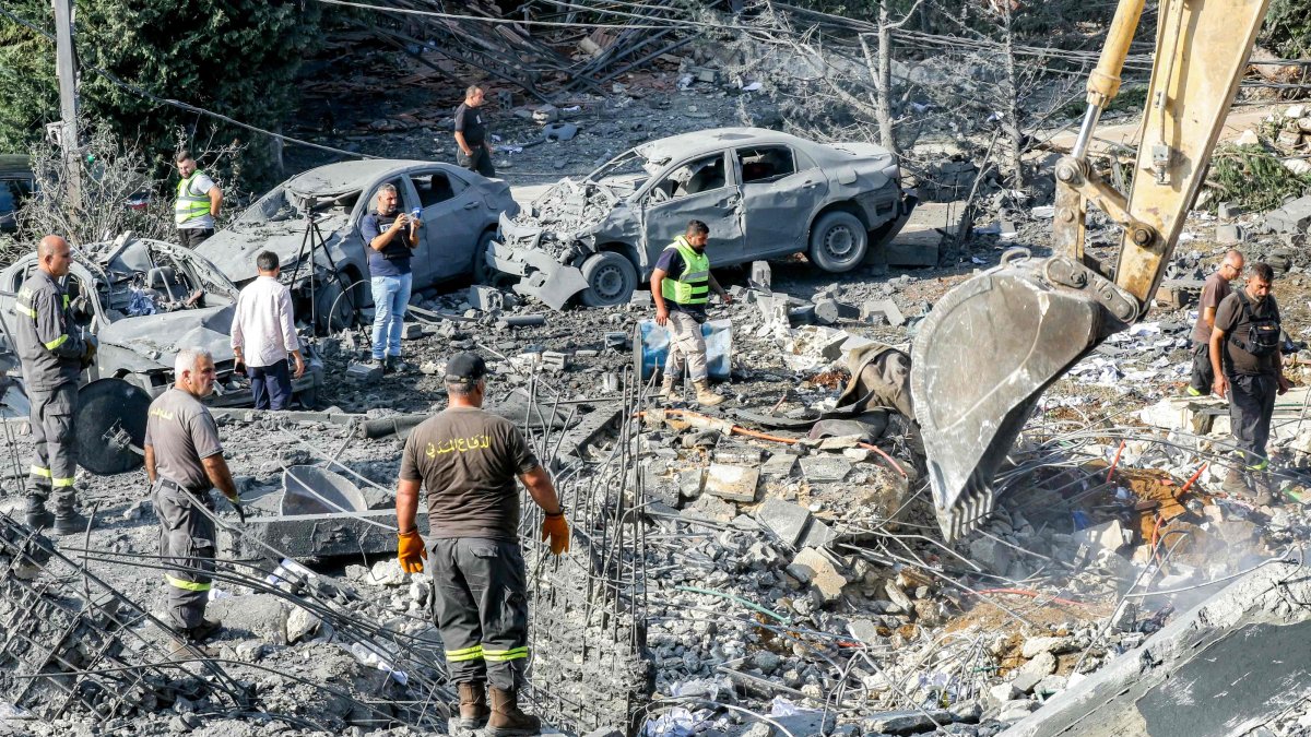 An excavator digs as rescuers search for survivors amidst the rubble following an overnight Israeli airstrike on the village of Kfar Roummane, Lebanon, Sept. 7, 2026. (AFP Photo)