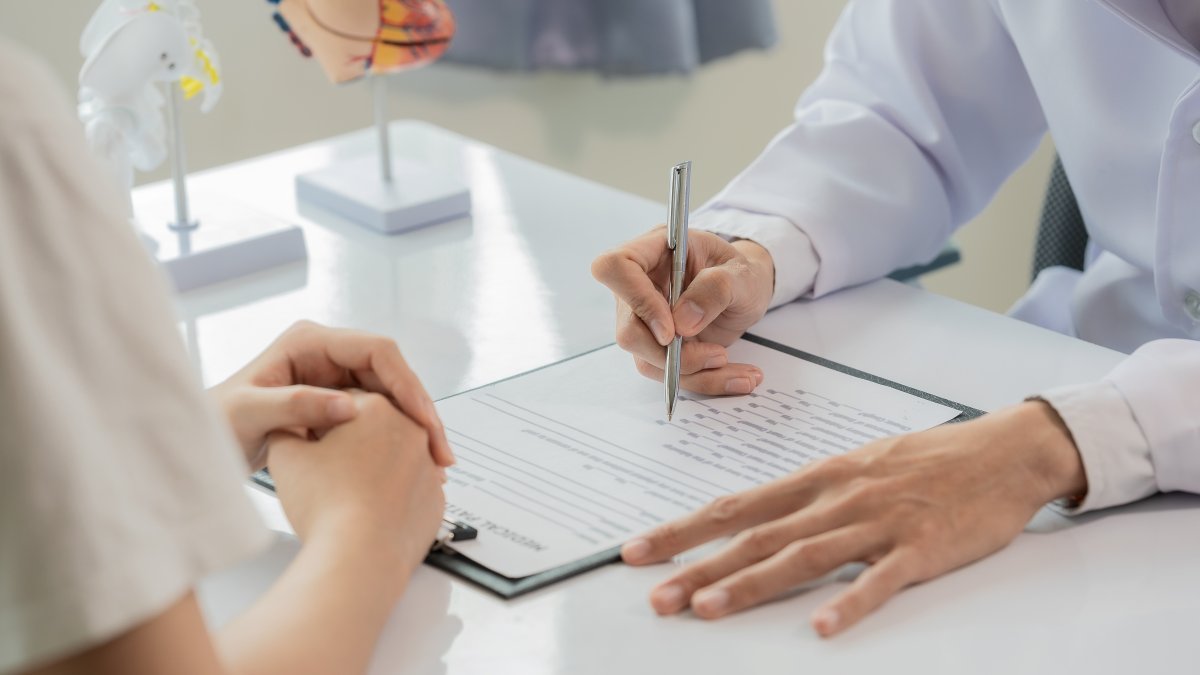 A doctor discusses a diagnosis with a patient during a consultation. (Shutterstock Photo)