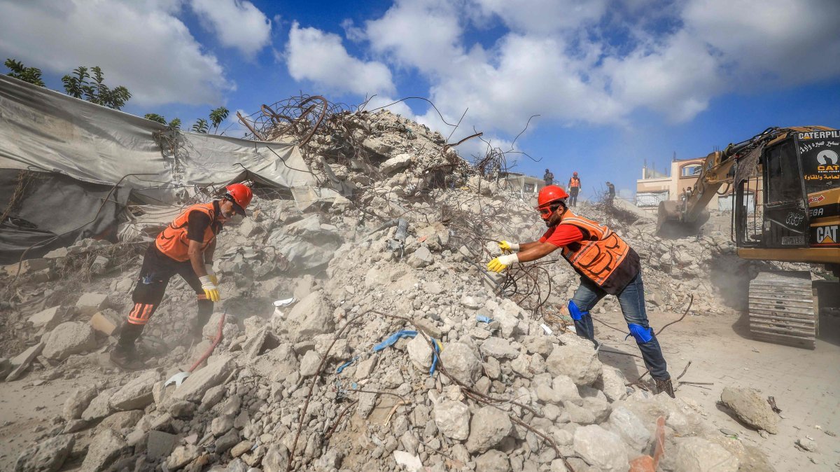Civil Defence personnel sift through the rubble of Al-Muhandisin Tower, which was destroyed in Israeli strikes in the early days of the war, Sept. 5, 2026. (AFP Photo)