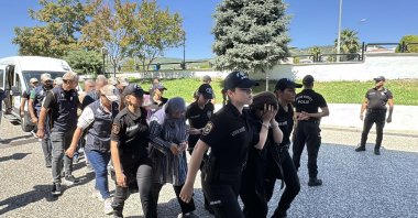 Ten suspects accused of providing financial support to a FETÖ member who was part of a squad targeting President Recep Tayyip Erdoğan during the 2016 coup attempt are escorted to a courthouse, Muğla, Türkiye, Sept. 7, 2026. (DHA Photo)