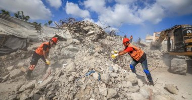 Civil Defence personnel sift through the rubble of Al-Muhandisin Tower, which was destroyed in Israeli strikes in the early days of the war, Sept. 5, 2026. (AFP Photo)