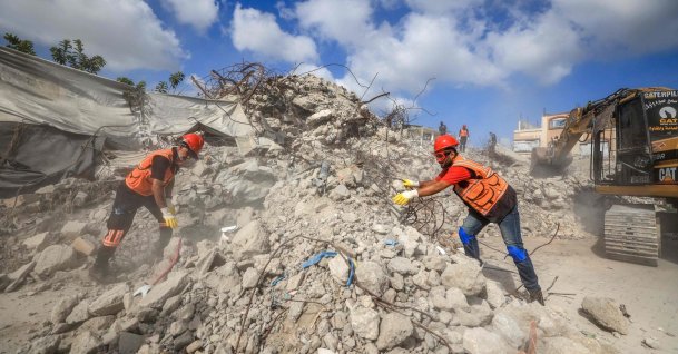 Civil Defence personnel sift through the rubble of Al-Muhandisin Tower, which was destroyed in Israeli strikes in the early days of the war, Sept. 5, 2026. (AFP Photo)