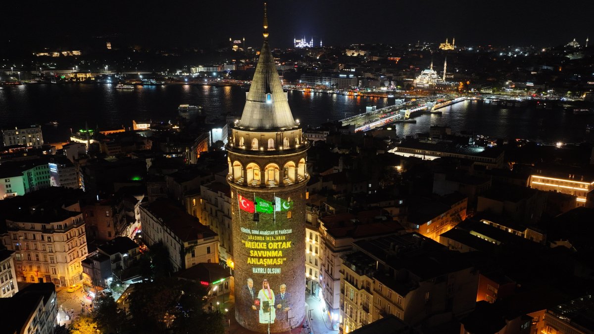 A drone-captured aerial view shows the historic Galata Tower reflecting the images of the leaders of three members of the Mecca pact, Istanbul, Türkiye, Aug. 10, 2026. (AA Photo)