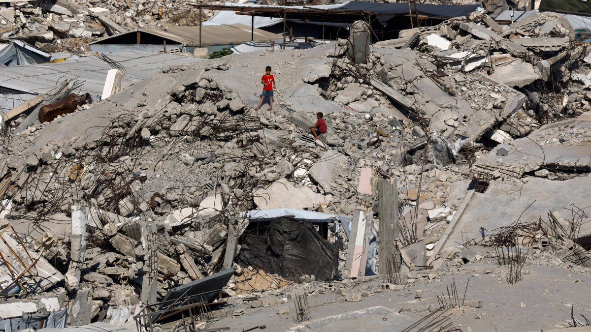 Young Palestinians amid the rubble of buildings destroyed during the war, at Jabalia refugee camp in the northern Gaza Strip, Palestine, Aug. 5, 2026. (Reuters Photo)