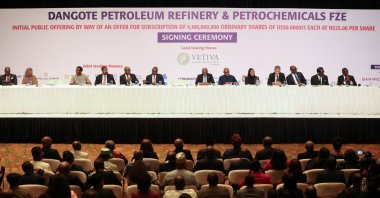 People sit in a hall as Aliko Dangote, president and CEO of Dangote Group, arrives for the signing ceremony for the Dangote Refinery initial public offering (IPO), Lagos, Nigeria, Sept. 7, 2026. (Reuters Photo)