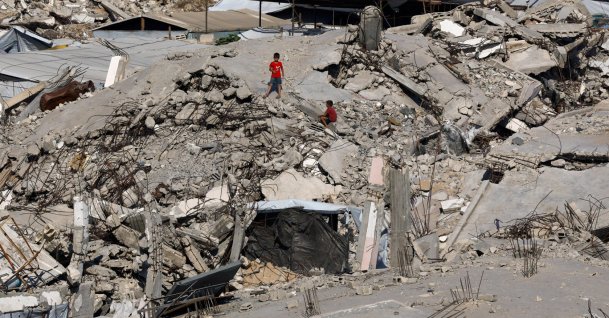 Young Palestinians amid the rubble of buildings destroyed during the war, at Jabalia refugee camp in the northern Gaza Strip, Palestine, Aug. 5, 2026. (Reuters Photo)