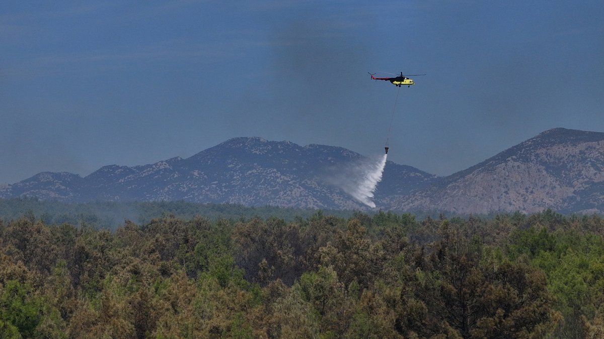 A helicopter conducts aerial firefighting over a forest fire, Aksu, Antalya, Türkiye, Sept. 9, 2026. (AA Photo)