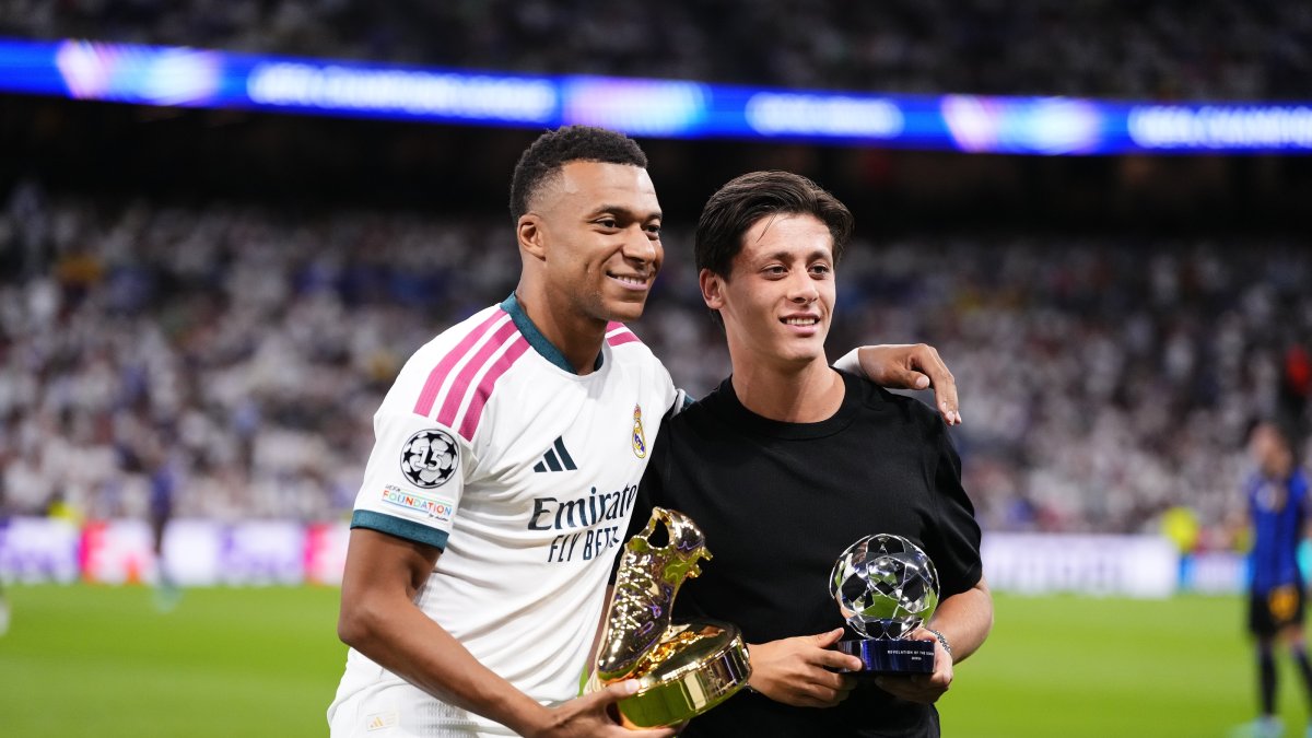 Real Madrid's Kylian Mbappe (L) and Arda Güler pose for a photo with their UEFA Champions League awards at Santiago Bernabeu, Madrid, Spain, Sept. 8, 2026. (AA Photo)