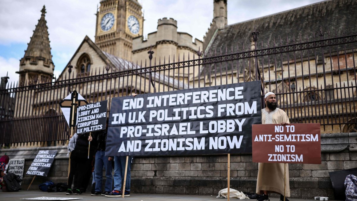 Protesters hold placards as a small group of people hold an anti-Israel demonstration outside the Houses of Parliament in central London, Sept. 9, 2026. (AFP Photo)