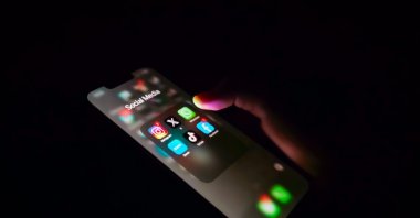A person is seen checking on social media applications on a smartphone, Indonesia, Dec. 2, 2025. (Shutterstock Photo)