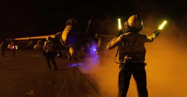 A U.S. sailor signals an F/A-18F Super Hornet on the flight deck of Nimitz-class aircraft carrier USS George H.W. Bush deployed in the Gulf, Sept. 1, 2026. (AFP Photo)