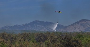 A helicopter conducts aerial firefighting over a forest fire, Aksu, Antalya, Türkiye, Sept. 9, 2026. (AA Photo)