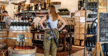 An Israeli soldier stands at a winery in the illegal Israeli settlement of Sha'ar Binyami, occupied West Bank, Palestine, Sept. 9, 2026. (AFP Photo)