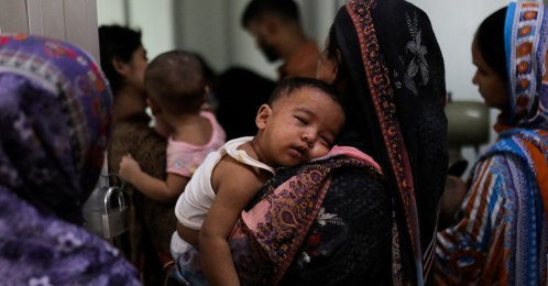 A woman carries a child, who suffers from measles, for treatment at a hospital in Dhaka, Bangladesh, Sept. 7, 2026. (Reuters Photo)