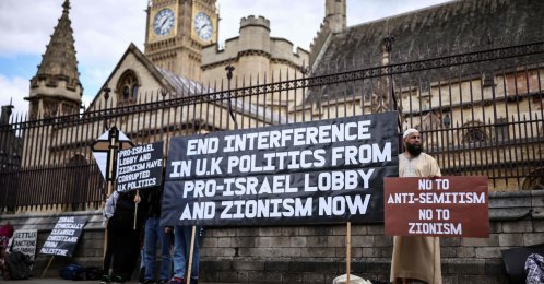 Protesters hold placards as a small group of people hold an anti-Israel demonstration outside the Houses of Parliament in central London, Sept. 9, 2026. (AFP Photo)