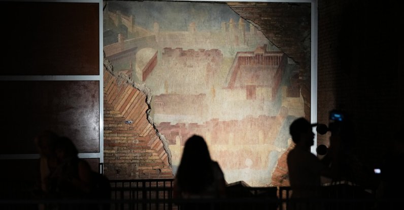 Reporters film the "The Painted City" fresco, discovered during 1990s built as foundations for the Baths of Trajan that has been restored, Rome, Italy, Sept. 8, 2026. (AP Photo)