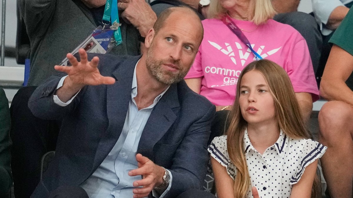 Britain's William, Prince of Wales speaks to Princess Charlotte as they sit in the audience to watch the track cycling at the Commonwealth Games, Glasgow, Scotland, Aug. 1, 2026. (AP Photo)