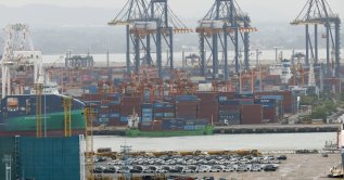 Stacked shipping containers and exported cars are prepared for shipment loading at Laem Chabang deep-sea port, Chonburi province, Thailand, Sept. 2, 2026. (EPA Photo)