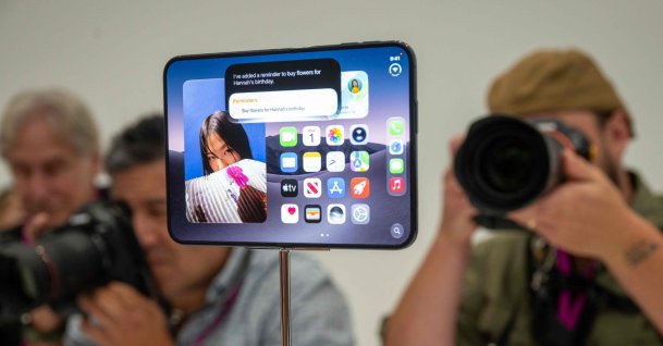 Journalists take photos of the new foldable iPhone Duo displayed during an Apple event at the Steve Jobs Theater in Apple Park, Cupertino, California, U.S., Sept. 9, 2026. (AFP Photo)