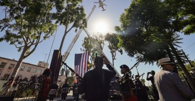 Participants watch as a Los Angeles Fire Department helicopter conducts a flyover during the 25th annual 9/11 Remembrance Ceremony in Los Angeles, California, Sept. 11, 2026. (EPA Photo)
