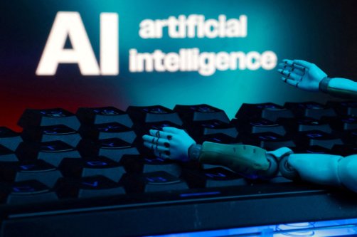 A message reading "AI artificial intelligence", a keyboard, and robot hands are seen in this illustration taken Jan. 27, 2025. (Reuters File Photo)
