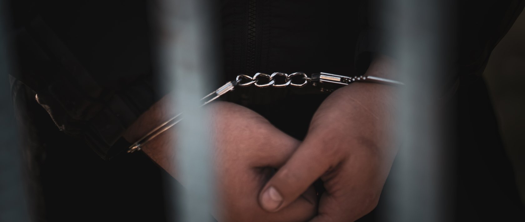 The handcuffed hands of a detainee. (Shutterstock Photo)